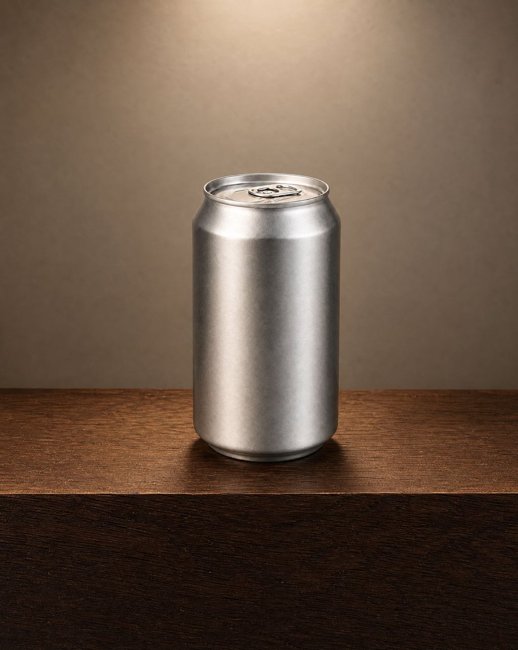 An aluminium beverage can on a dark wooden ledge against a warm brown wall, lit by a soft pool of light from above