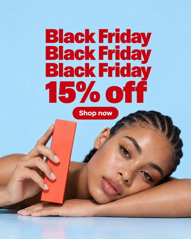 cosmetic product box beauty product photo: A woman rests her head on a reflective surface while holding a coral-colored cosmetic box against a bright blue stud…