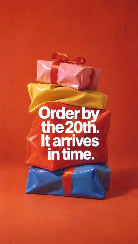 gift-wrapped presents still life product photo: A stack of glossy, colorful gift-wrapped boxes sits against a vivid red studio backdrop, with bold white deadli…