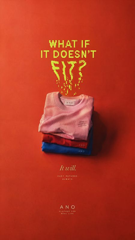 folded T-shirts still life product photo: A stack of folded, colorful T-shirts sits against a saturated red studio backdrop, with bright distressed headline le…
