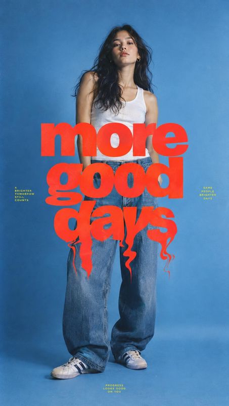 wide-leg jeans look book product photo: A woman in a white tank top, loose blue jeans, and sneakers poses against a blue studio backdrop beneath oversized red…
