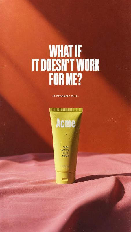 skin cream still life product photo: A yellow skin-care tube stands on rippled pink fabric against a warm terracotta backdrop, with bold white headline text an…