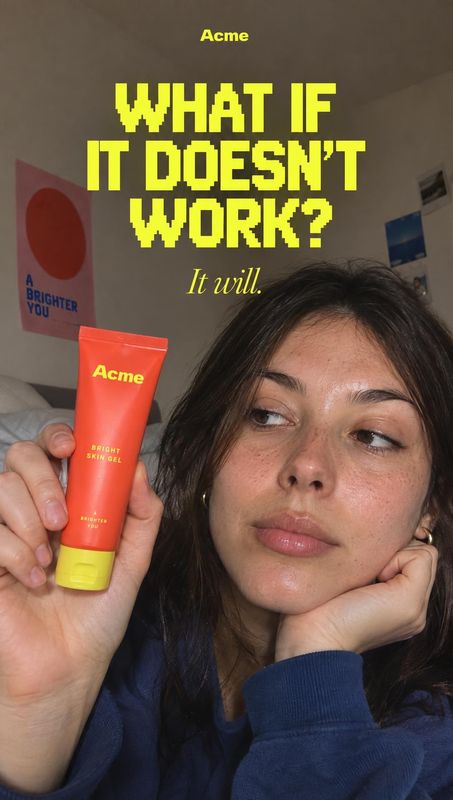 bright skin gel product in hand product photo: An adult woman holds a bright red skincare gel beside her face in a casual indoor selfie, while bold yellow head…