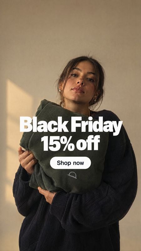 cushion home product photo: A woman in a dark knit outfit holds a deep green cushion against a warm beige wall, lit by soft golden sunlight, with bold Black Fr…