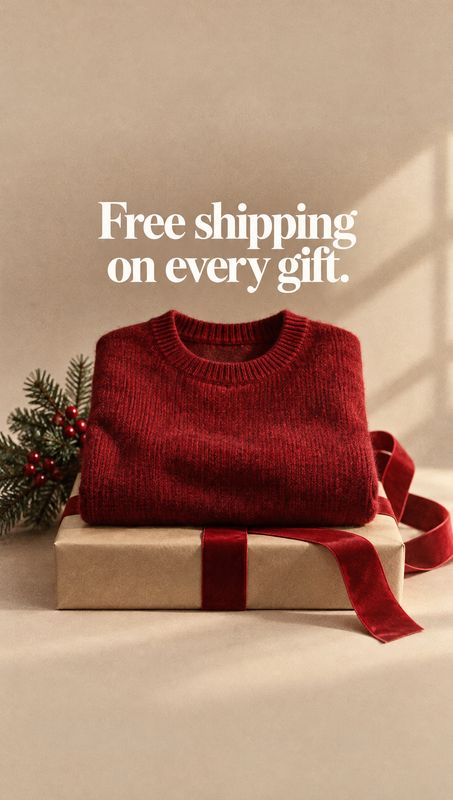 red knit sweater christmas product photo: A folded red knit sweater sits atop a kraft-paper gift box tied with a velvet ribbon, with a small evergreen sprig ne…