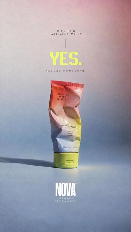 skincare tube packshot product photo: A crumpled skincare tube stands against a softly graduated pink-to-blue studio backdrop, with bold neon lettering and min…