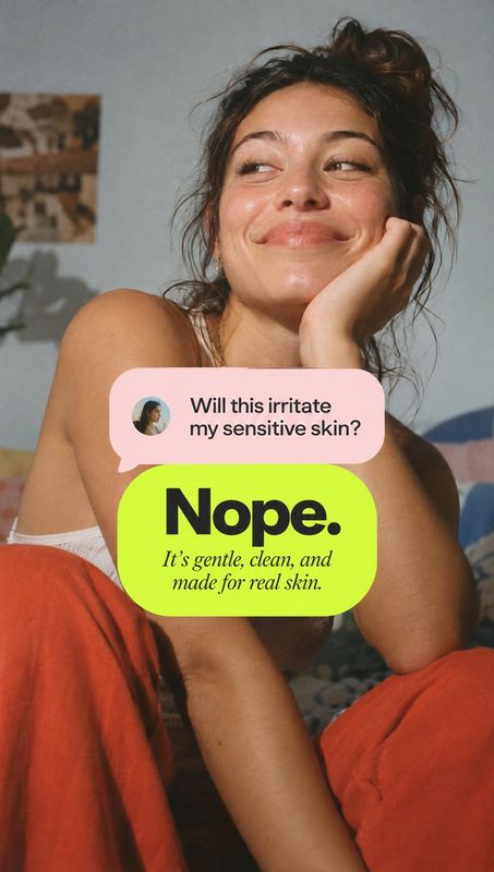 beauty close-up product photo: A woman in a relaxed pose smiles in a softly lit bedroom-like interior, with bold pastel speech bubbles promoting a gentle skinc…