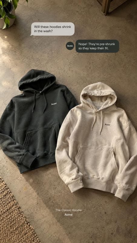 hoodies flat lay product photo: Black and cream hoodies are arranged on a concrete floor beneath chat-style text, with soft natural light and a casual, underst…