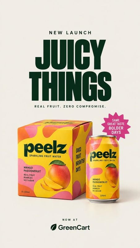 sparkling fruit water packshot product photo: Bright yellow-and-orange fruit water packaging is arranged against a warm cream studio backdrop beneath oversized…