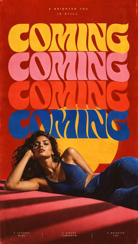 blue denim outfit posters product photo: A woman reclines in a blue denim outfit against a vivid red-and-yellow studio backdrop, with oversized colorful letter…