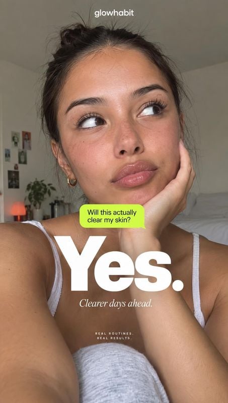 beauty close-up product photo: A woman in a white tank top rests her hand against her cheek in a softly lit home interior, with bold skincare-focused text laye…