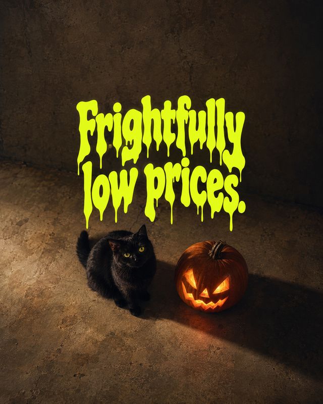 halloween product photo: A black cat sits beside a glowing jack-o'-lantern on a dark, textured floor beneath oversized neon-yellow dripping sale lettering, cre…