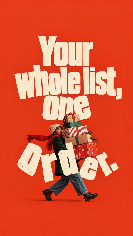 christmas product photo: A bundled-up adult strides across a vivid red studio backdrop carrying a tall stack of wrapped holiday gifts, framed by oversized crea…