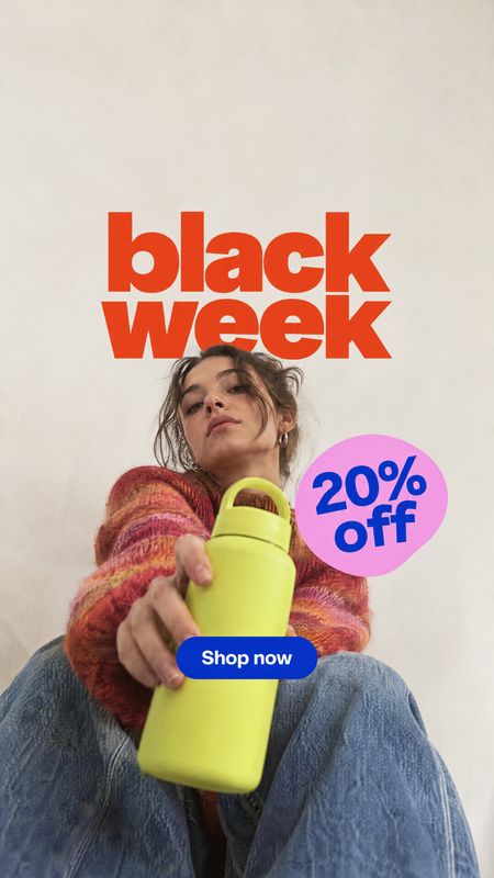 water bottle product in hand product photo: A woman in a colorful sweater holds a bright lime water bottle toward the camera against a pale studio backdrop, wi…