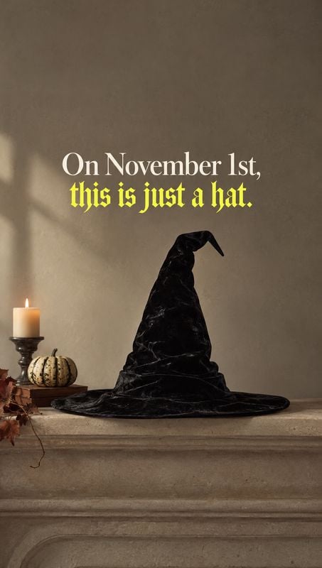 witch hat halloween product photo: A black velvet witch hat rests on a stone mantel beside a lit candle and small pumpkin, with dramatic warm shadows and bold…