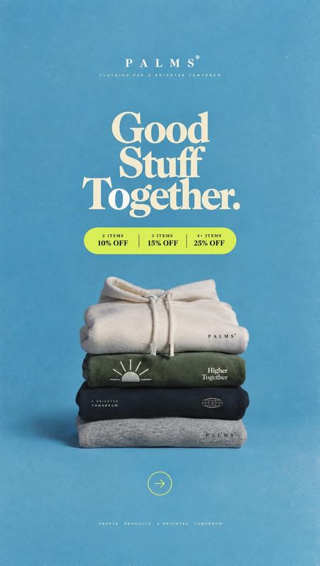 stack of folded sweatshirts group lineup product photo: A neatly stacked set of neutral and dark sweatshirts sits against a textured blue studio backdrop, with…