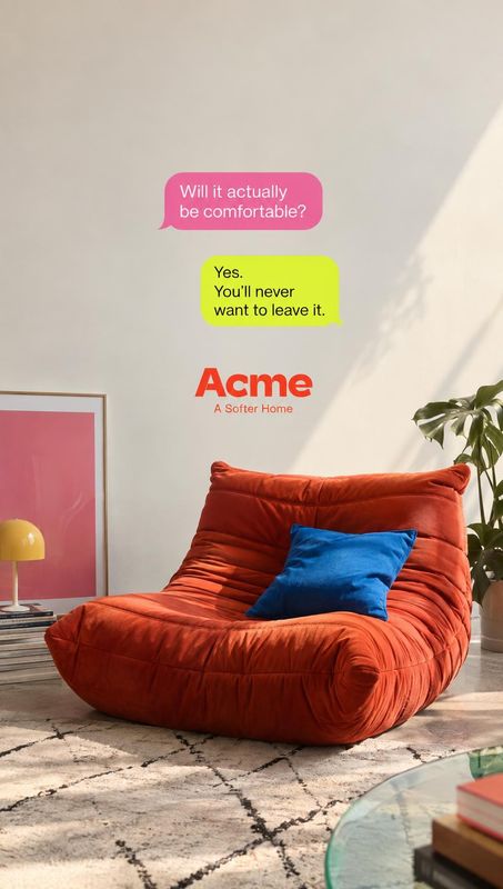 red lounge chair room set product photo: A plush red lounge chair with a bright blue cushion sits in a sunlit living room, styled with plants and colorful acce…