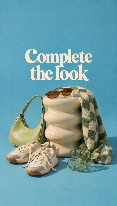 fashion accessories and sneakers still life product photo: Sneakers, a green handbag, sunglasses, a checked scarf and perfume are artfully arranged on a sculpt…