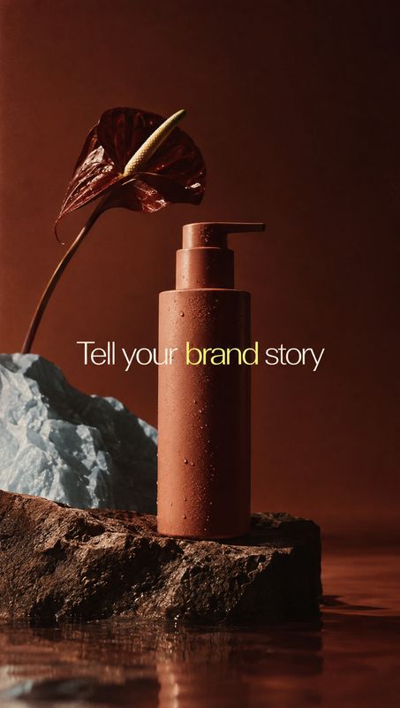 pump bottle still life product photo: A terracotta-colored pump bottle stands among rugged rocks and shallow water beside a dark botanical leaf, lit with drama…