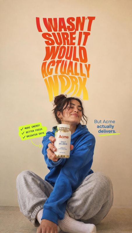 daily balance supplement jar product in hand product photo: A woman in a blue sweatshirt holds a supplement jar against a warm beige studio backdrop, framed by…
