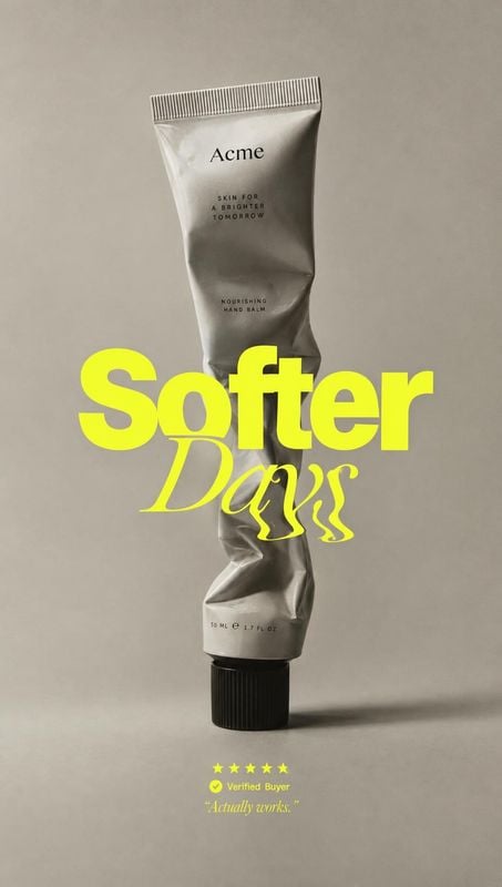 nourishing hand balm packshot product photo: A crumpled silver hand-balm tube stands against a warm gray studio backdrop, overlaid with bold neon-yellow “Softe…