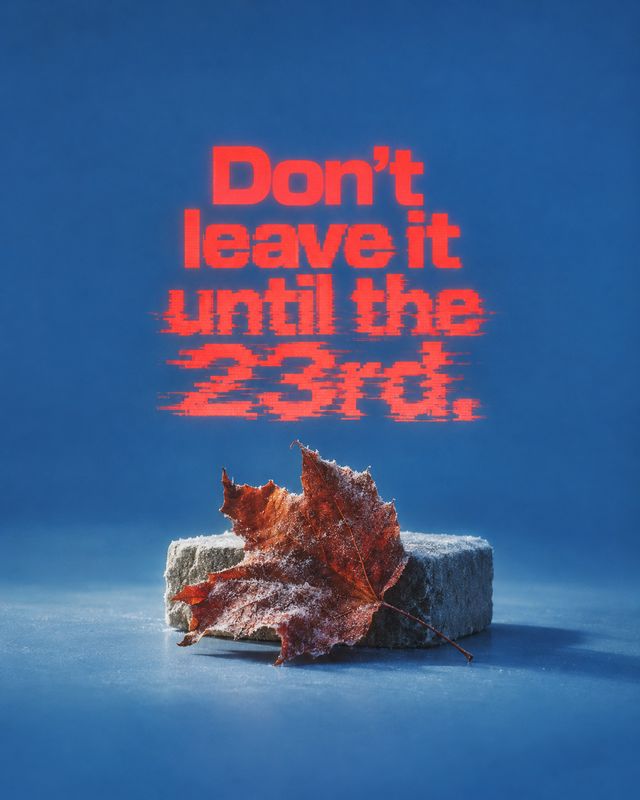 autumn product photo: A frost-covered autumn leaf rests on a stone block against a vivid blue studio backdrop, beneath bold distressed red lettering for a cool…