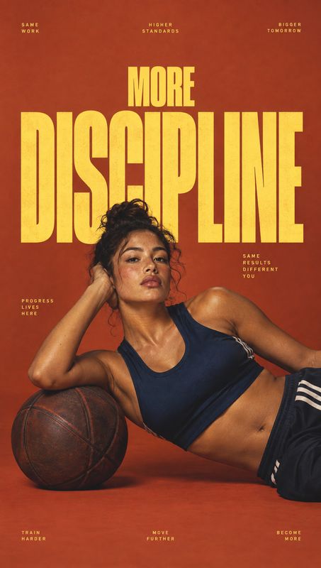 athletic wear sports product photo: An athletic woman in a navy sports top and track pants reclines beside a basketball against a rust-red studio backdrop, wit…