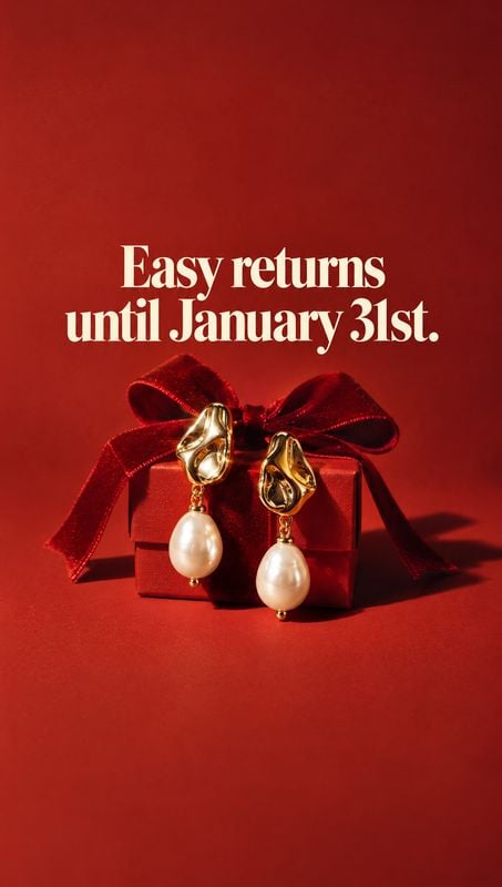 pearl drop earrings jewelry product photo: Gold-tone pearl drop earrings rest against a red gift box tied with a velvet bow on a saturated red studio backdrop,…