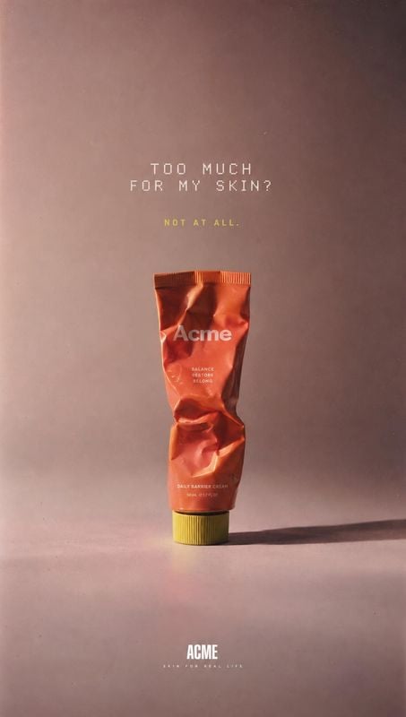 daily barrier cream packshot product photo: A crumpled coral skincare tube stands against a muted mauve studio backdrop, with warm directional light, a long sh…