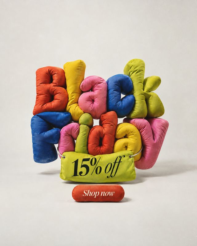 colorful cushion-letter display home product photo: Brightly colored padded letters spell out a Black Friday message above a yellow cushion reading “15% off,”…