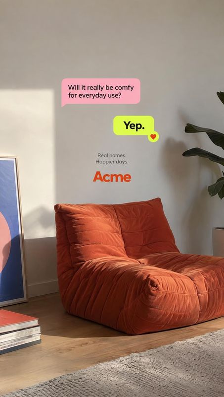 upholstered lounge chair room set product photo: A rust-orange cushioned lounge chair sits in a softly sunlit living room, with a leafy plant and framed art ne…