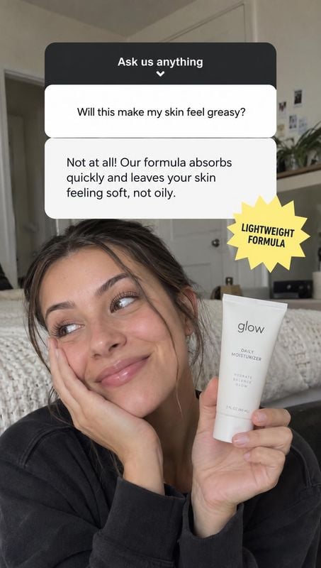 daily moisturizer product in hand product photo: A smiling woman holds a daily moisturizer beside her face in a softly lit bedroom, with conversational Q&A bub…