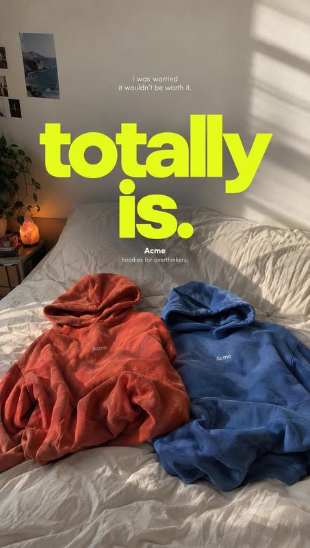 hoodies fashion product photo: Two red and blue hoodies lie across a rumpled bed in a warmly lit bedroom, beneath oversized neon-yellow slogan typography that…