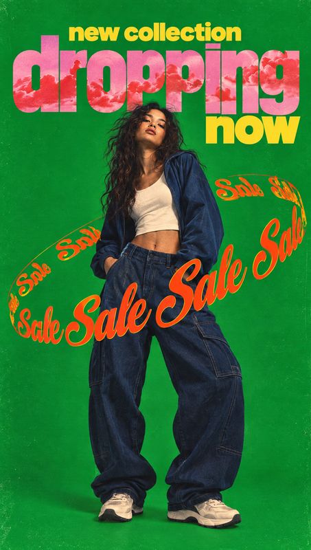 baggy jeans black friday product photo: A model poses in oversized jeans, a white crop top and a dark jacket against a vivid green studio backdrop, with bold p…