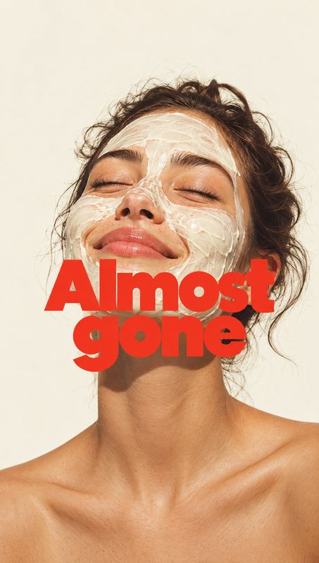 facial mask on-body detail product photo: A woman with a creamy facial mask closes her eyes against a warm, pale studio backdrop, while bold red “Almost gone”…