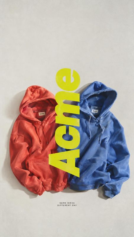 hoodies flat lay product photo: Two red and blue hoodies are arranged flat against a pale background, with bold vertical neon-yellow lettering and small center…