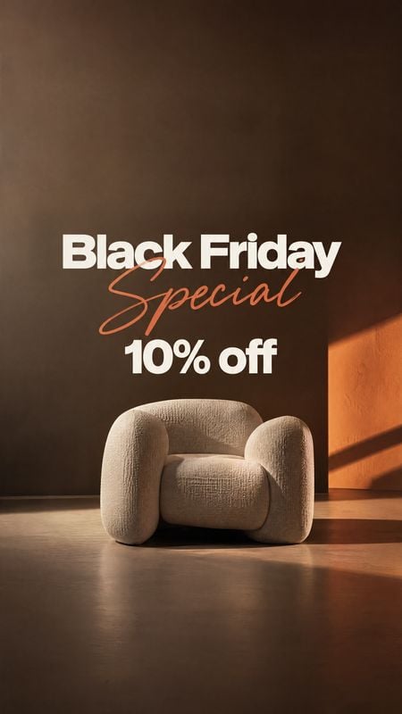 upholstered armchair room set product photo: A sculptural beige armchair sits in a warm, shadowy interior with orange side lighting, beneath bold Black Friday…