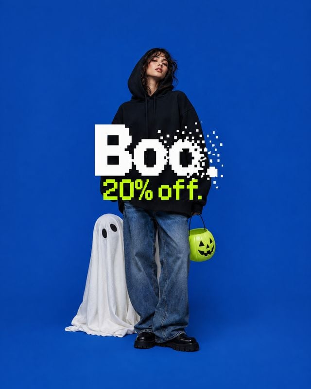 hoodie and jeans outfit halloween product photo: A model in a black hoodie and loose jeans stands against a vivid blue studio backdrop with a ghost and jack-o'…
