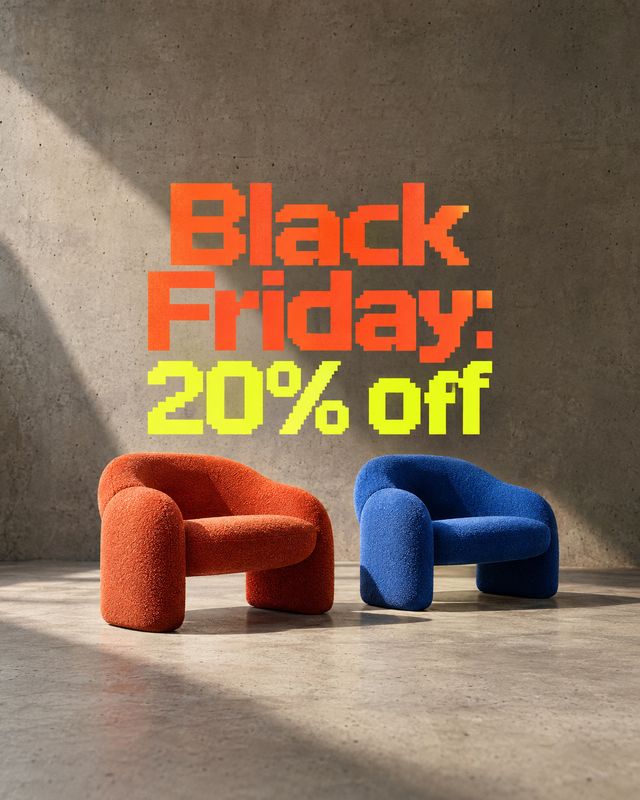 upholstered accent chairs room set product photo: Two sculptural upholstered chairs in rust and cobalt sit against a sunlit concrete wall beneath bold orange a…