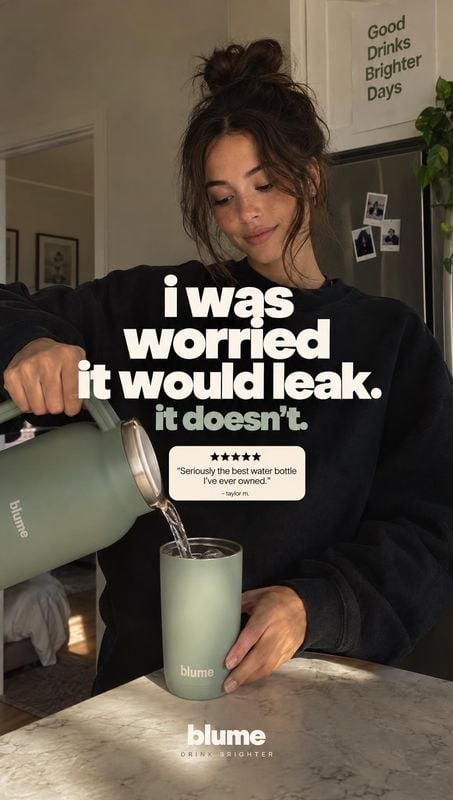 insulated tumbler splash / pour product photo: A woman pours water from a sage-green Blume bottle into a matching tumbler in a softly lit home, with bold testi…