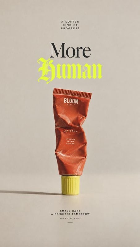 lip balm packshot product photo: A crumpled red lip balm tube with a yellow cap is centered against a warm beige studio backdrop, framed by bold black and neon…