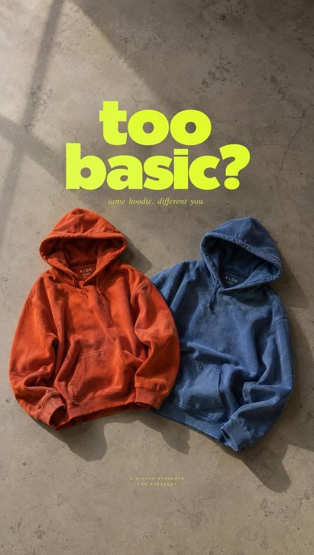 hoodies flat lay product photo: Two rust-orange and navy hoodies lie on a textured concrete floor in angled sunlight, beneath a bold lime-green headline for a…