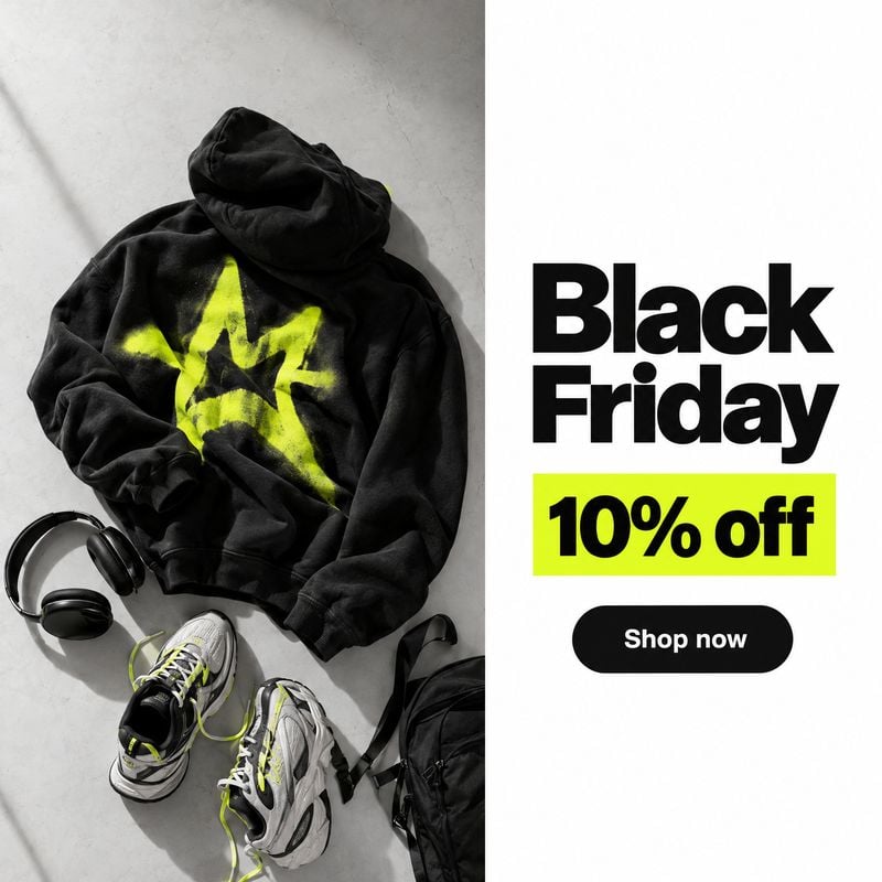 hoodie, sneakers, headphones and backpack flat lay product photo: A black graphic hoodie, sneakers, headphones and backpack are arranged on a pale concrete sur…