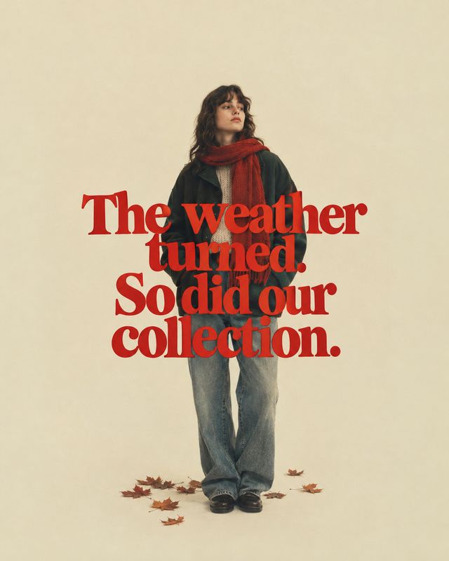 autumn clothing collection autumn product photo: A model in a dark jacket, red scarf and relaxed jeans stands against a warm cream studio backdrop with fallen…