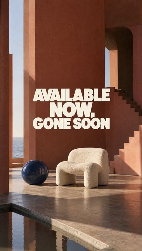 upholstered accent chair room set product photo: A sculptural cream chair and blue sphere sit in a sunlit terracotta interior beside a reflective pool, with bo…