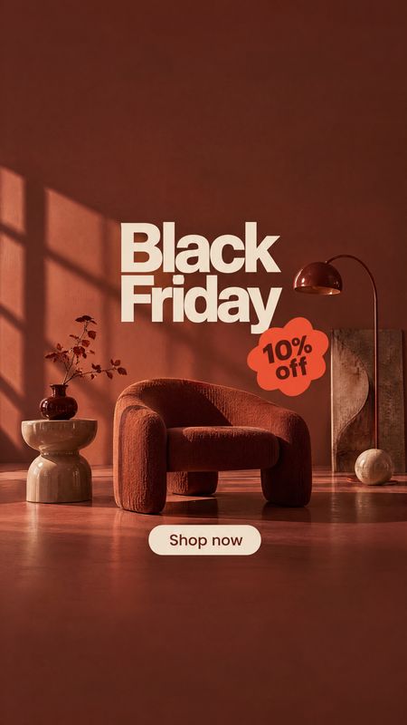 upholstered armchair interior space product photo: A sculptural rust-colored armchair sits in a warmly lit modern interior with a side table, lamp, and decorat…