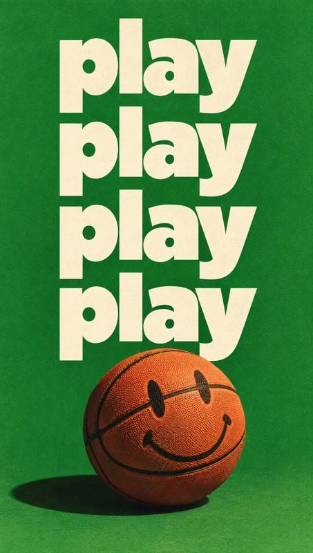 basketball sports product photo: A smiley-faced basketball rests on a green studio floor beneath repeated oversized cream “play” lettering, creating a bold, pl…