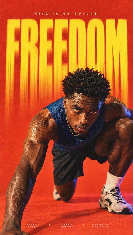 athletic apparel and sneakers sports product photo: An athletic man crouches in a runner’s starting pose against a vivid red studio backdrop, beneath towering…