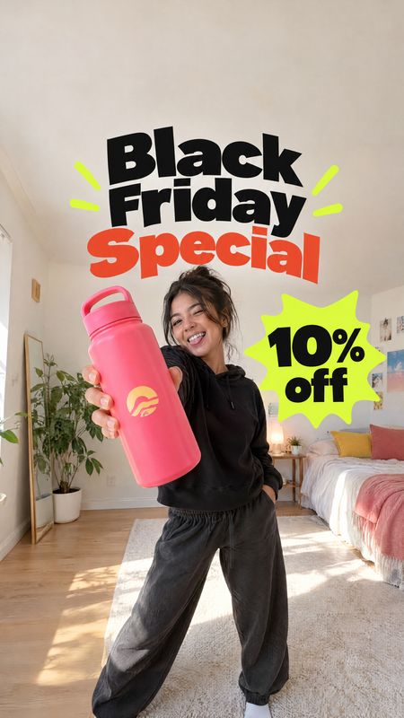 reusable water bottle sports product photo: A smiling woman presents a bright pink reusable bottle in a sunlit bedroom, with bold Black Friday sale lettering a…