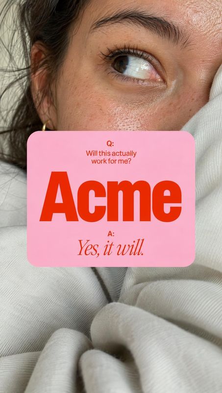 close-up detail product photo: A close-up portrait of a woman in a white sweater looks upward behind a pink card with bold red skincare-themed copy, creating a…